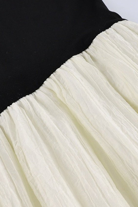 Amelie asymmetrische maxi-jurk met contrasterende details